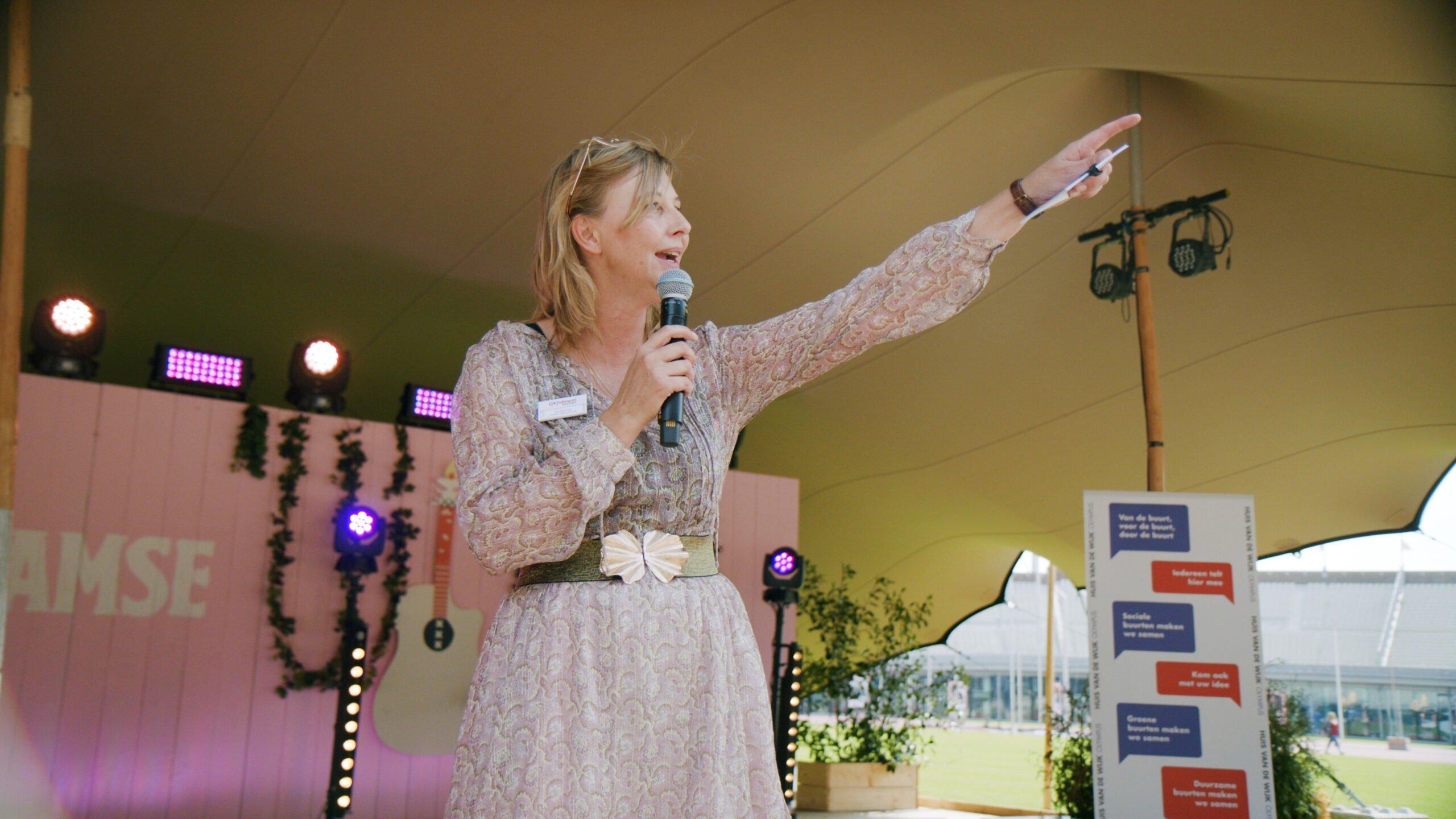 A person holds a microphone.